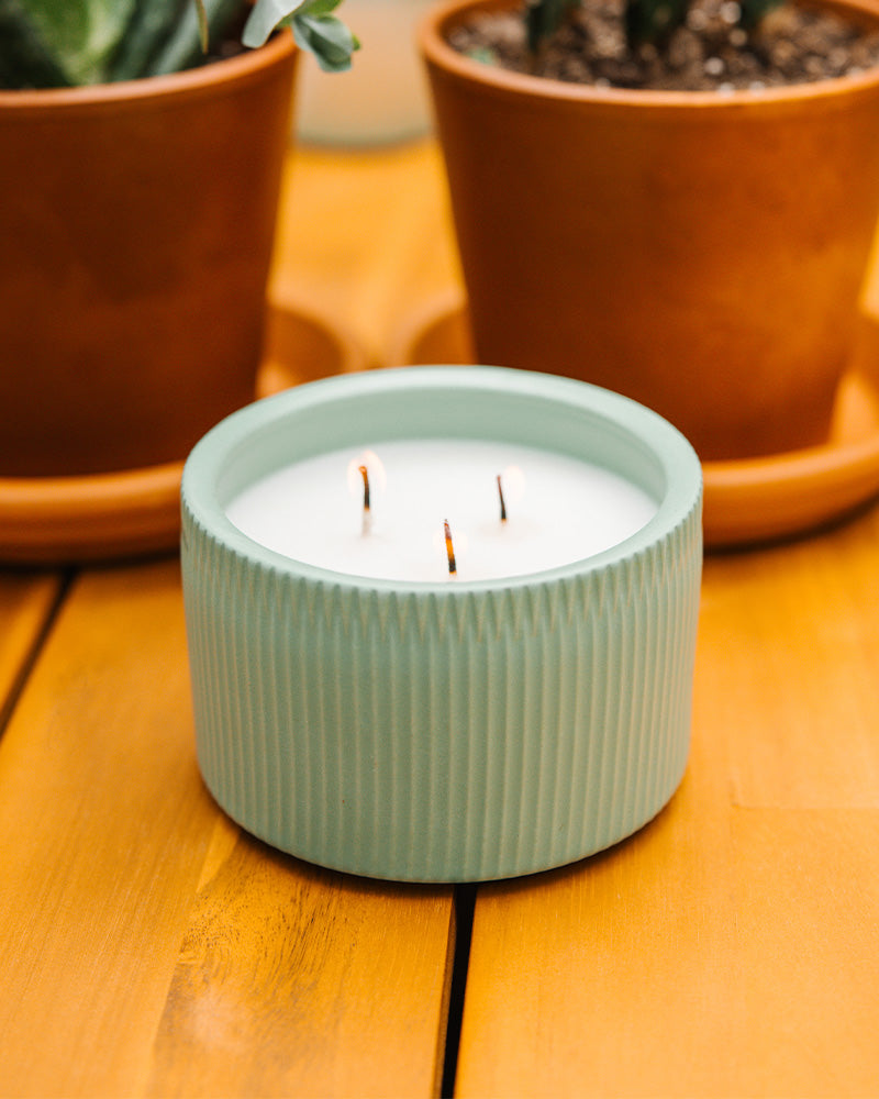 A Light Blue 3-Wick Ceramic Candle scented like Desert Stargaze.