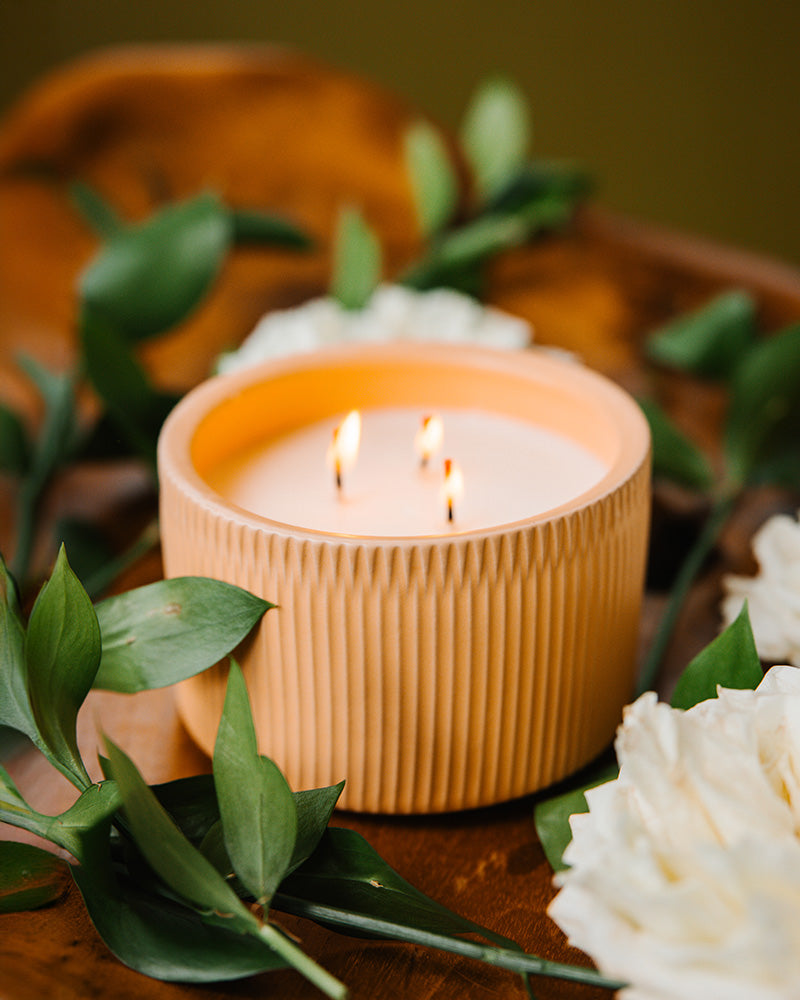 A Light Pink-Brown colored 3-Wick Ceramic Candle Scented like Peony & Santal.