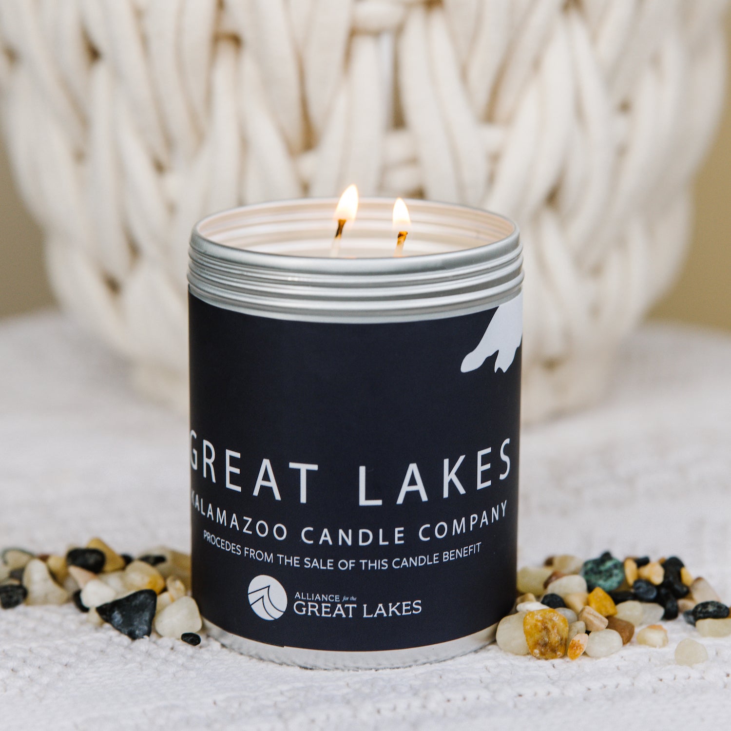 A Frontal shot of the Great Lakes candle surrounded by stones