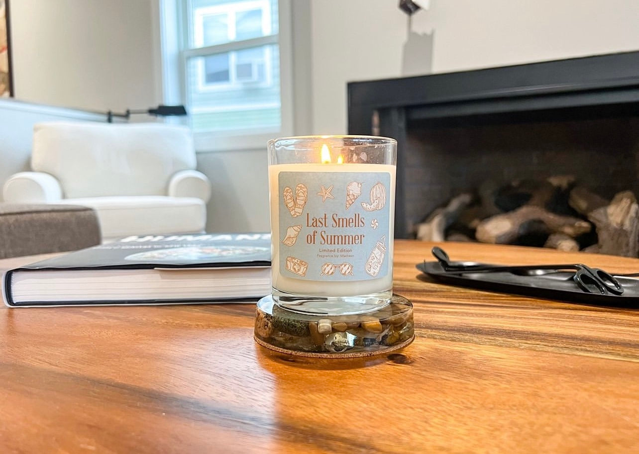A Candle Called "Last Smells of Summer" On a wooden table.