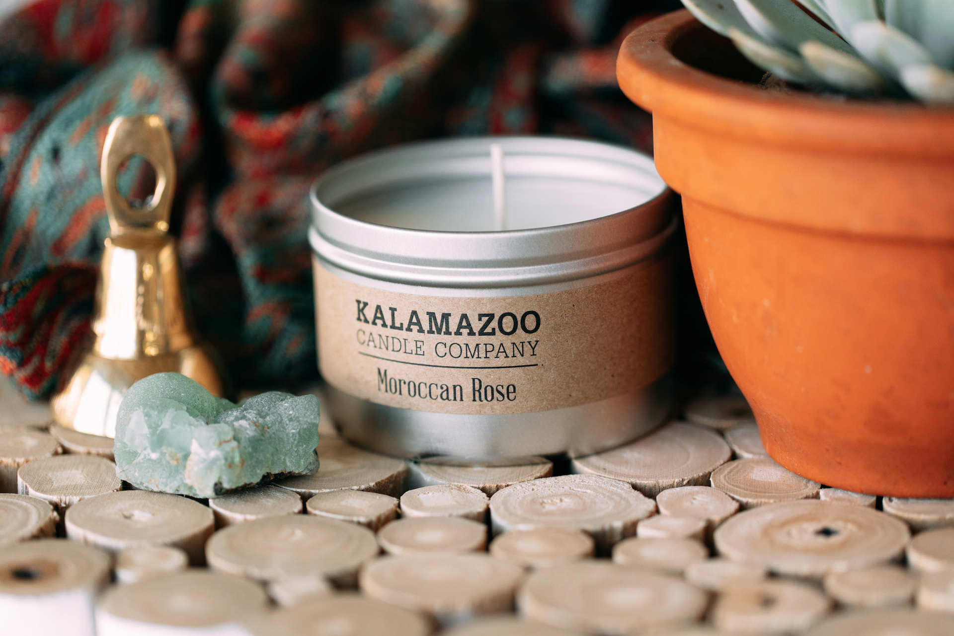 Moroccan Rose candle tin surrounded with collectables.