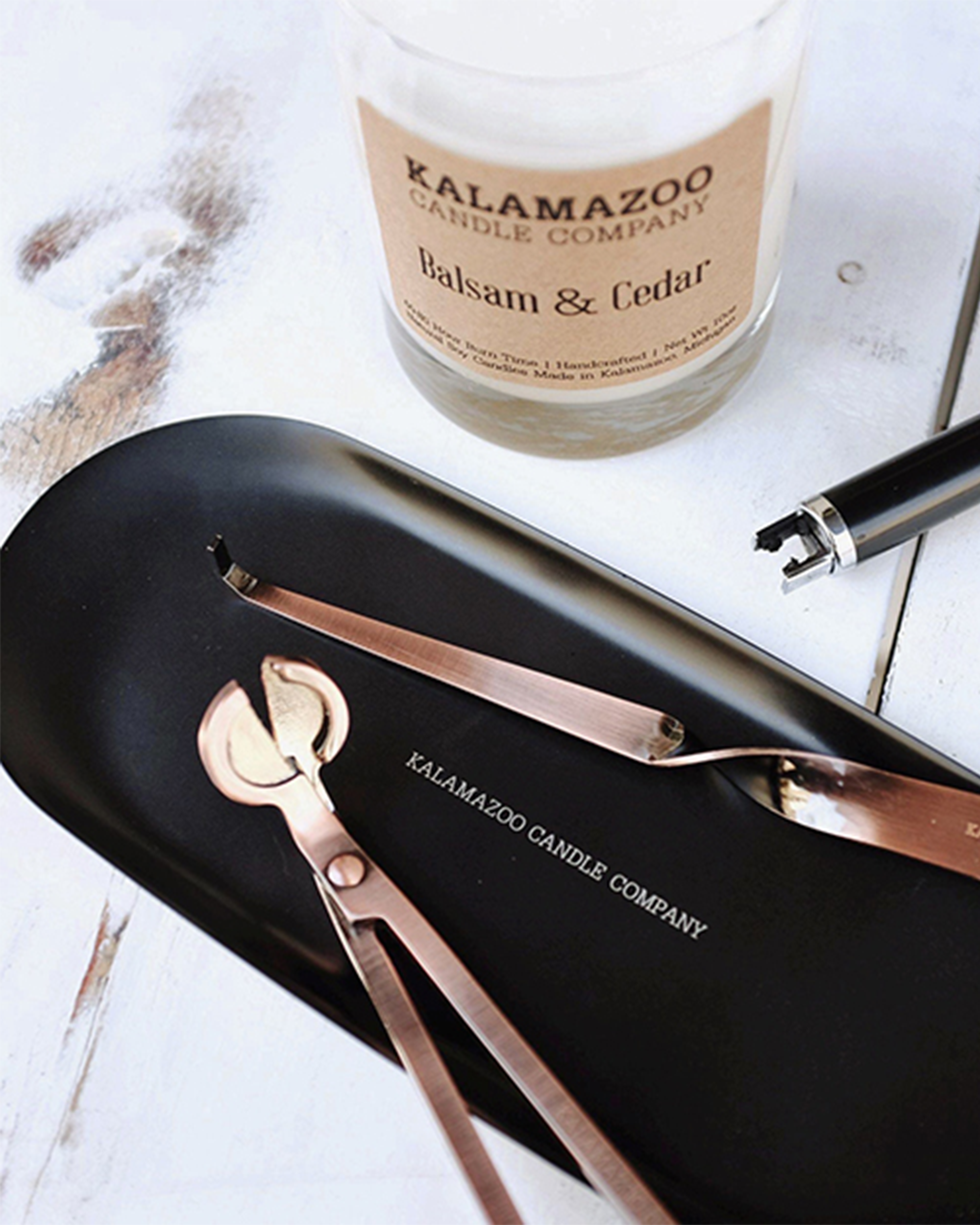 A Black Accessory Tray with Copper Tools.