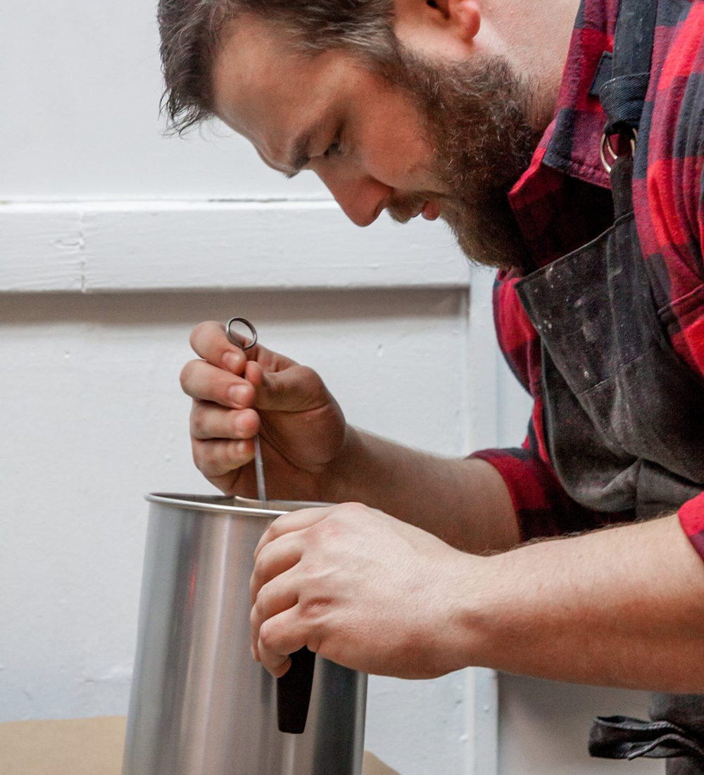 Owner Adam mixing candles