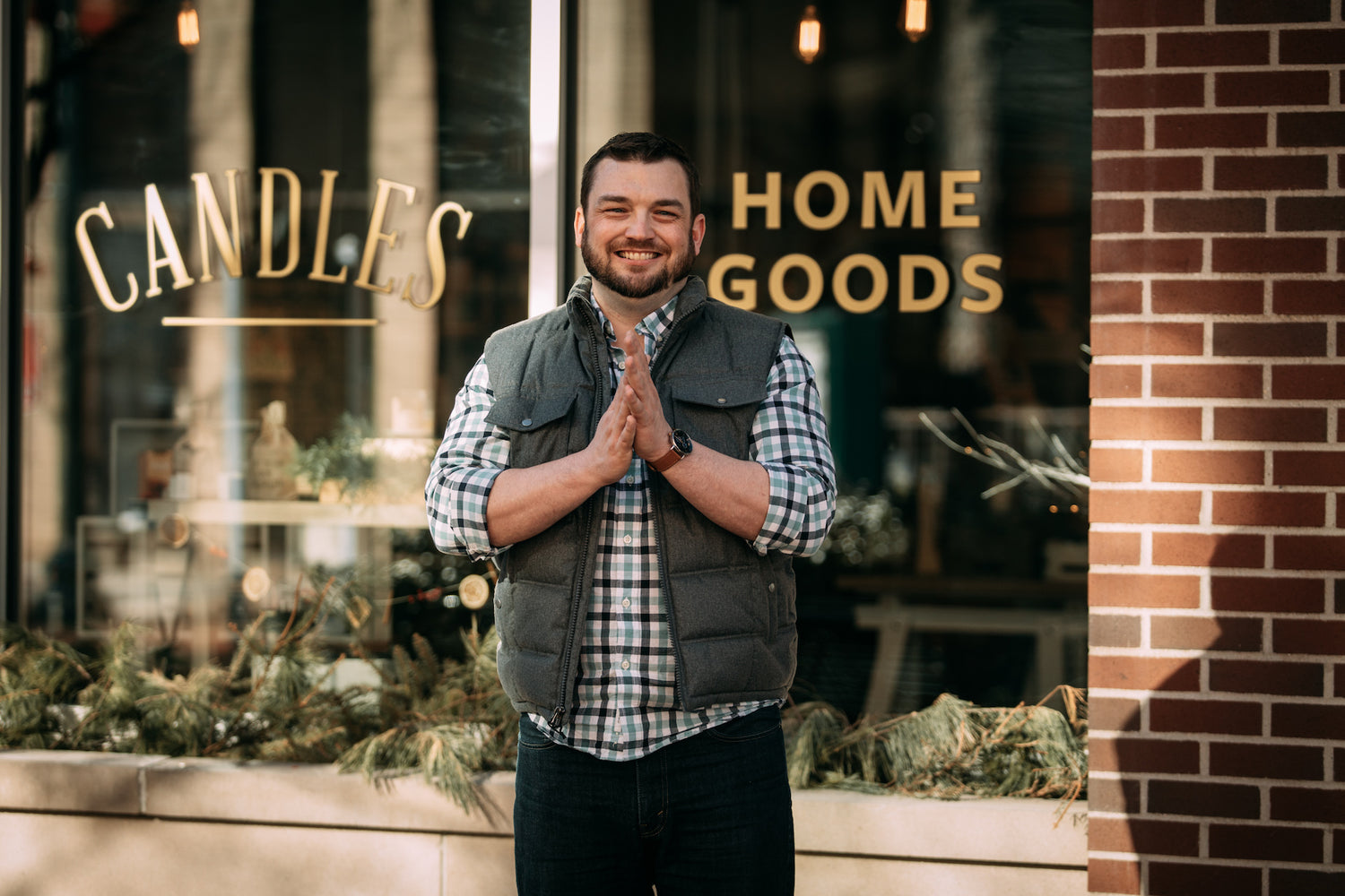 Owner Adam standing in front of the first Kalamazoo Candle Store