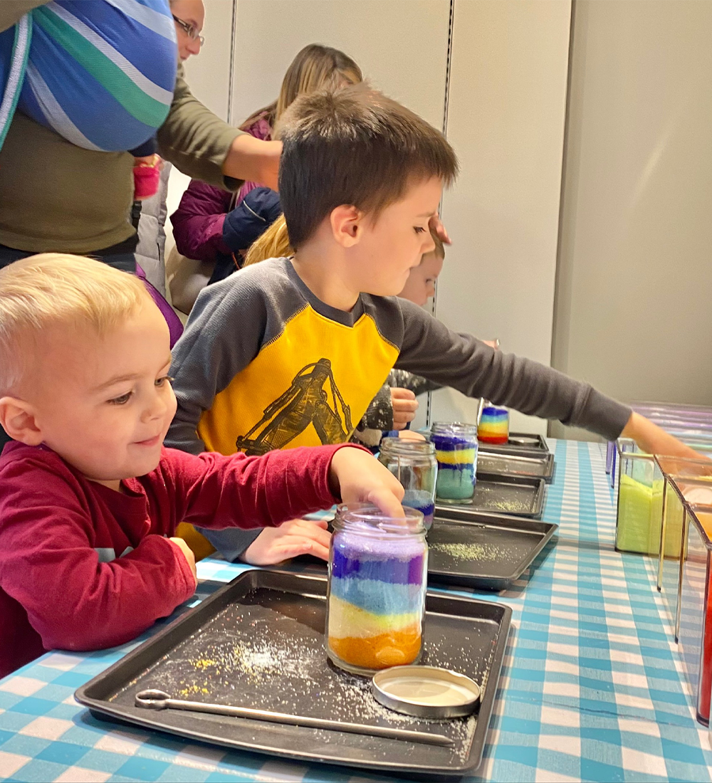 Children making sand candles