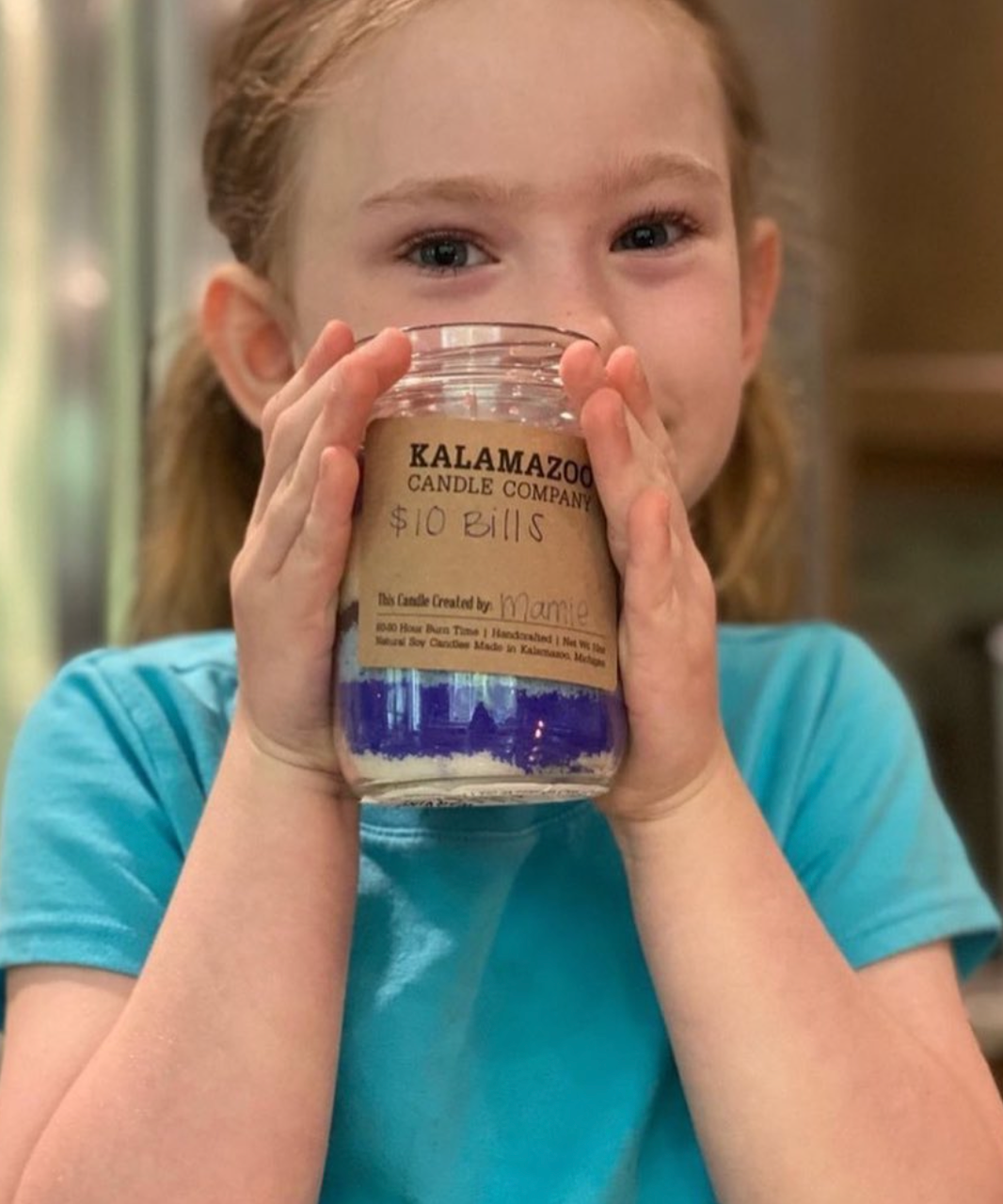 A young child with a sand candle