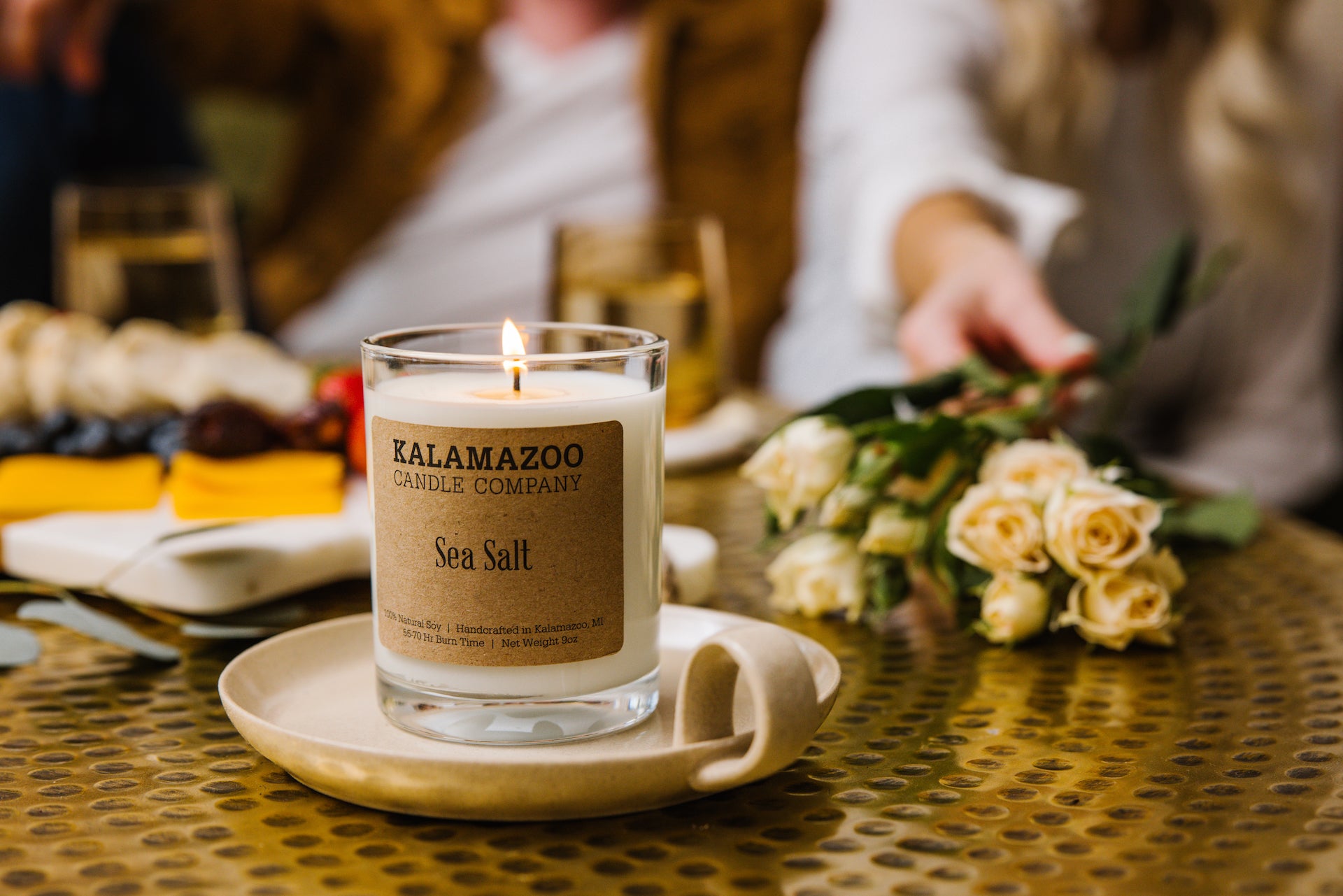 Sea Salt Candle in front of a charcuterie board