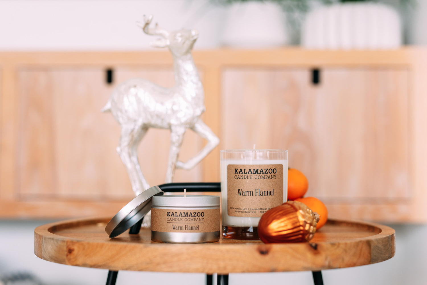 Two Warm Flannel Candles on a wooden table