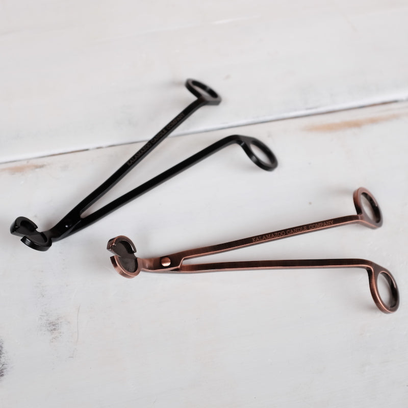 A Black Wick Trimmer and a Copper Wick Trimmer