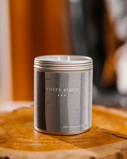 A Large Grey tin with birch trees on the side. Made in the USA In Kalamazoo, MI. Scented with Bergamot Leaf, Lemon, and Clary Sage.