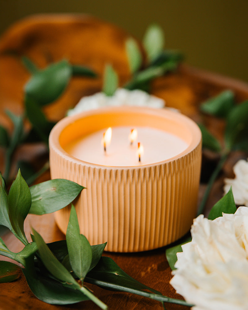 A Light Pink-Brown colored 3-Wick Ceramic Candle Scented like Peony &amp; Santal.