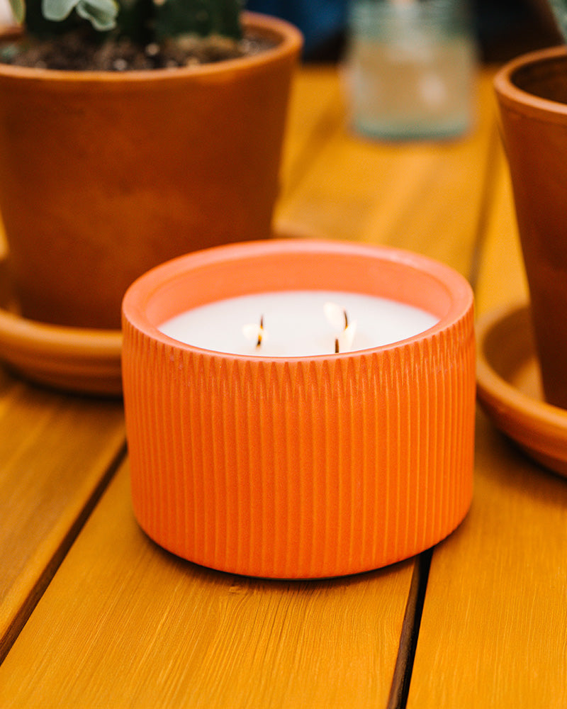 A Red-Brown colored 3-Wick Ceramic Candle scented like Redwood Forest.