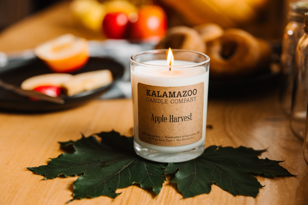 An Apple Harvest Candle on an apple leaf.