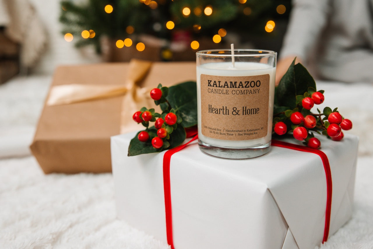 A Hearth & Home Candle on top of a present box