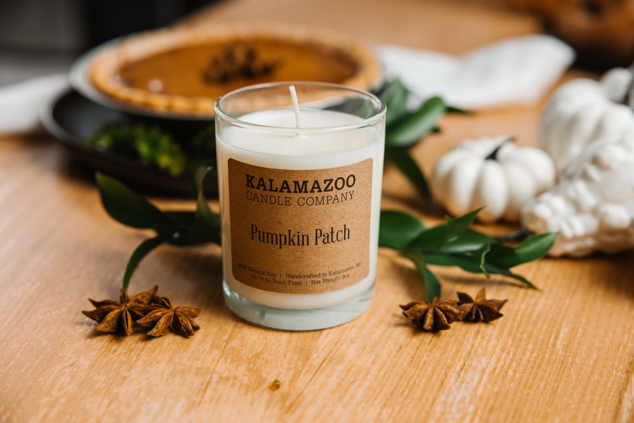 A Pumpkin Patch Candle on a wooden table