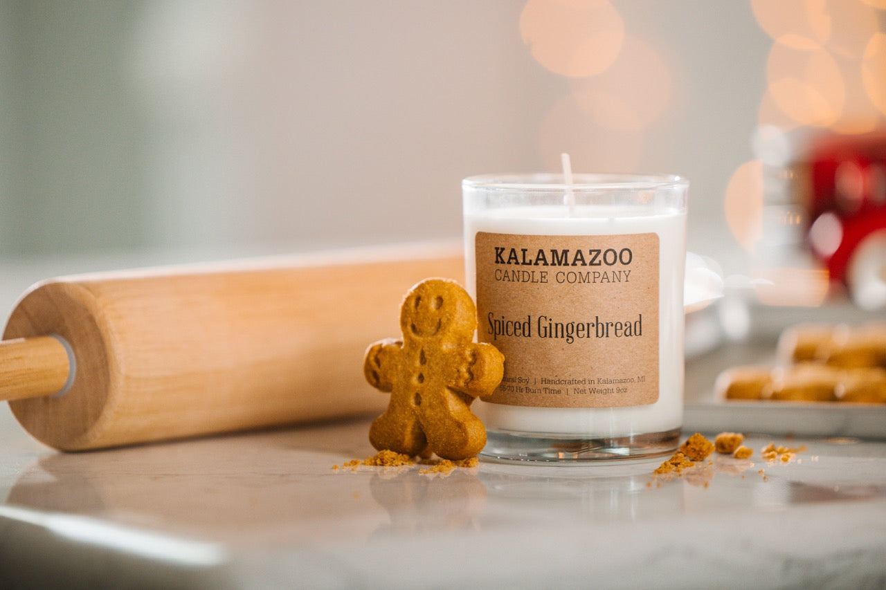 A Spiced Gingerbread Candle with a Gingerbread man and rolling pin.