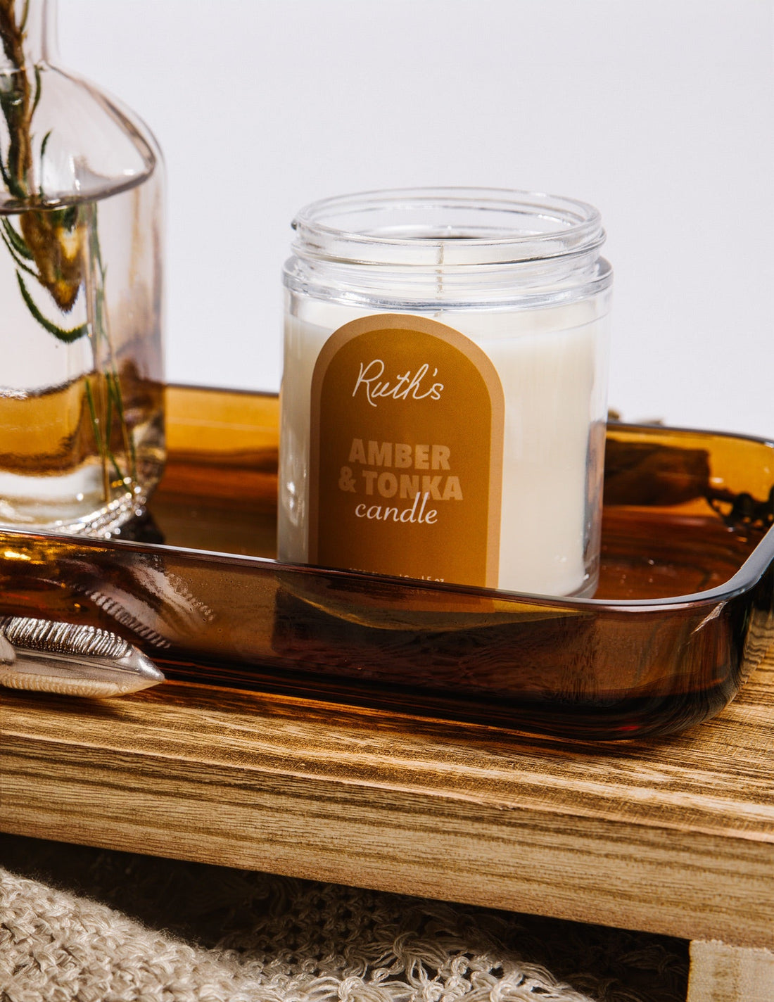 A Lifestyle Image of an Amber &amp; Tonka candle