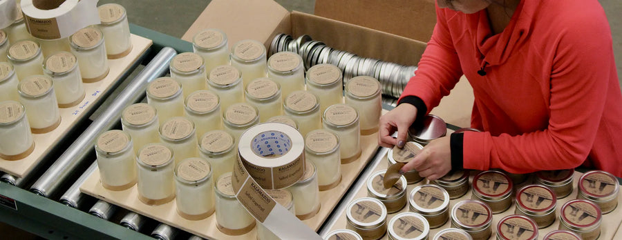 Kalamazoo Candle team applying labels to custom candle tins