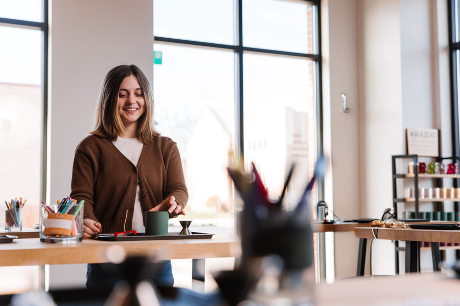 Guest blending her own candle scent at a candle bar workstation