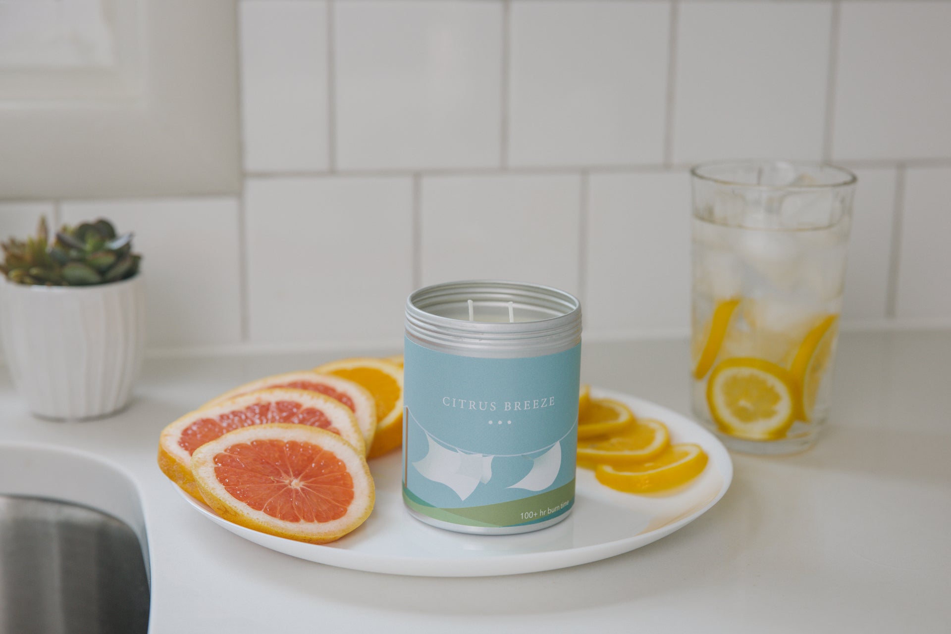 Citrus Breeze candle on a plate with citrus