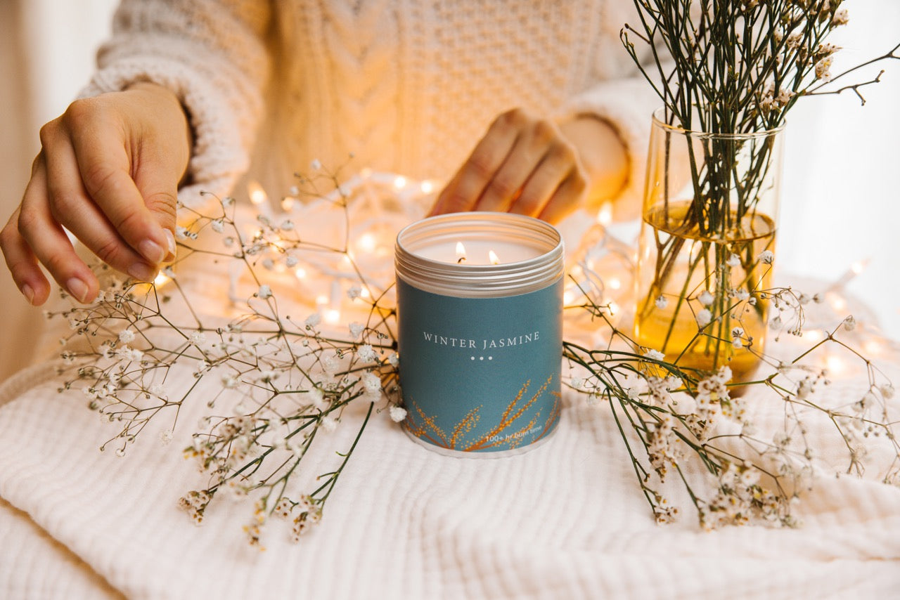 A Winter Jasmine Candle Surrounded by white jasmine