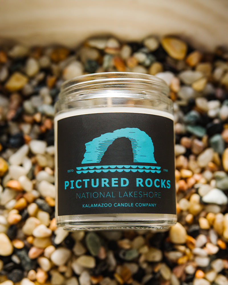 Graphic Pictured Rocks National Lakeshore jar candle filled with reviving orange blossom and white sage offer a robust foundation for the day.