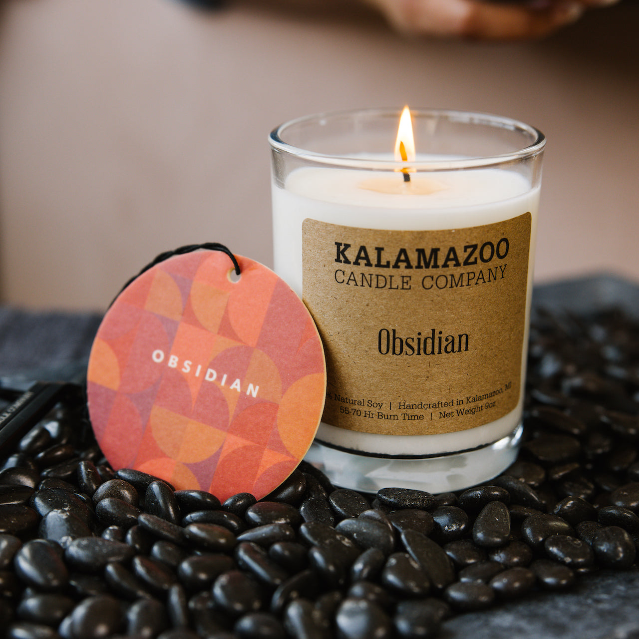 Obsidian Candle and car freshener on a bed of obsidian rock