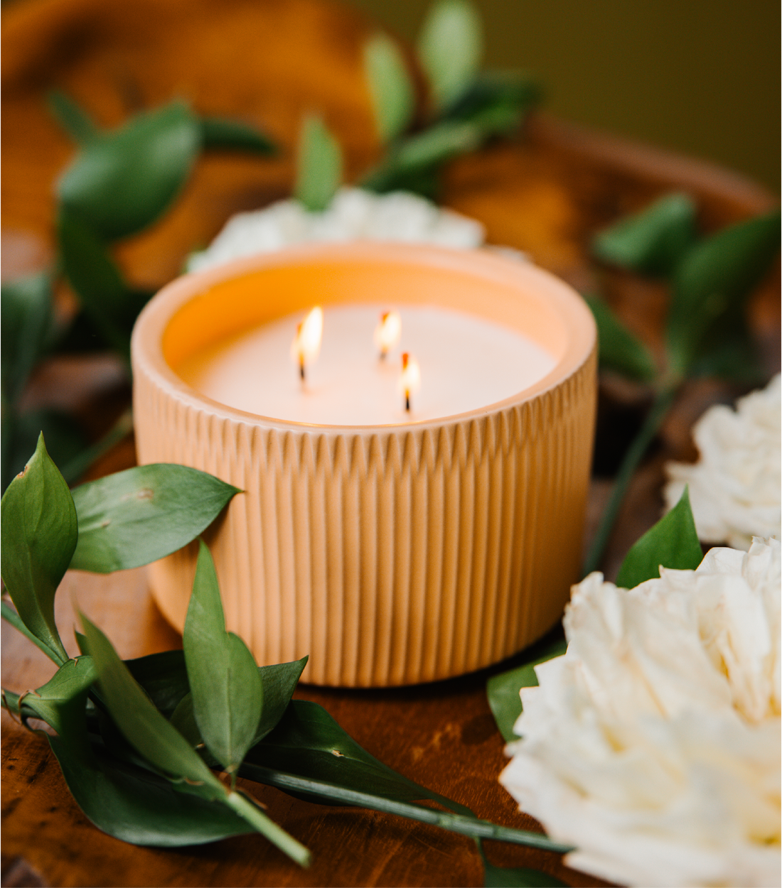 A Light Pink-Brown colored 3-Wick Ceramic Candle Scented like Peony &amp; Santal.