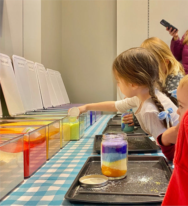 Kids making layered sand candles at Kalamazoo Candle Company