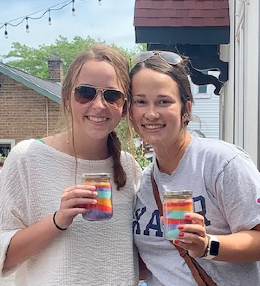 2 Friends holding Sand Candles