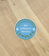 A Blue circular sticker that says "Introverted but willing to discuss candles".