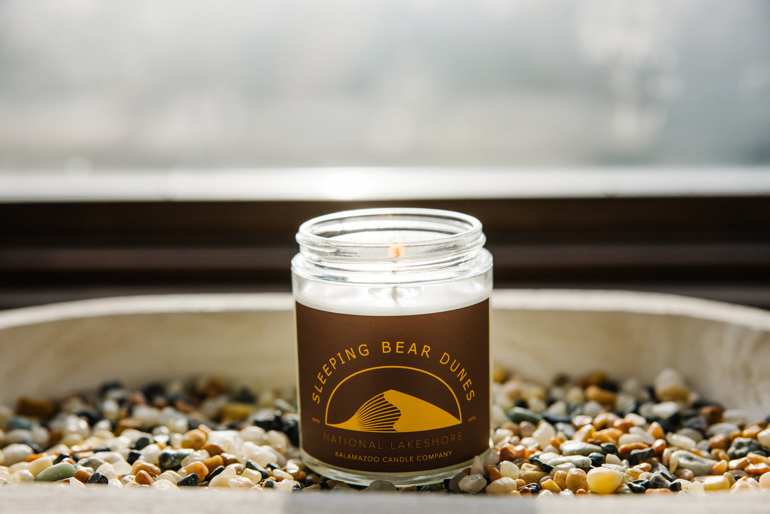 Sleeping Bear Dunes Candle on a bed of stones