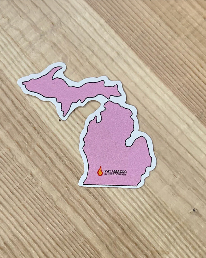 A Pink Sticker Shaped like the state of Michigan with a flame over Kalamazoo
