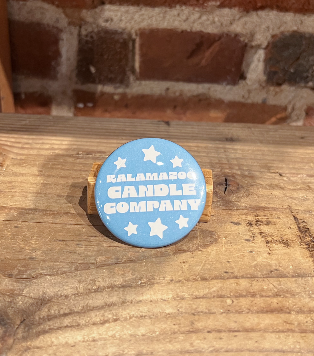 A blue button that says Kalamazoo Candle Company