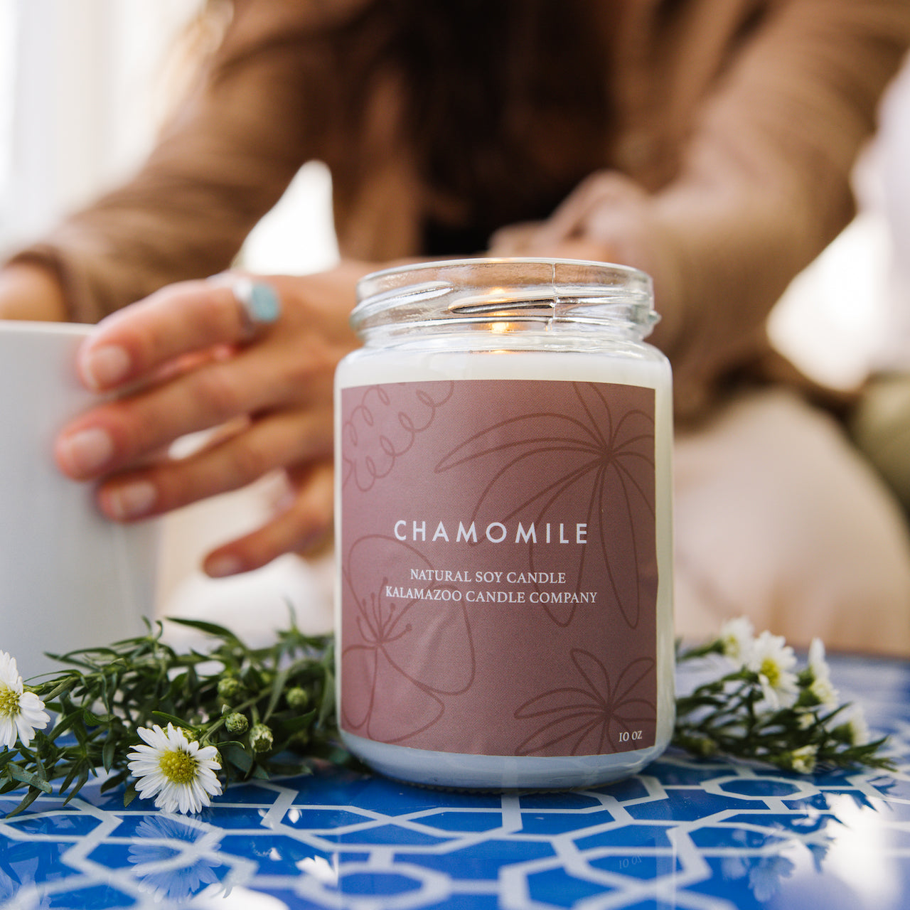 Chamomile candle on a outdoor table
