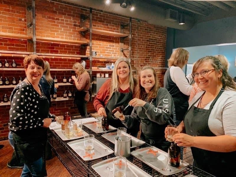 Women making their own candles together at the Kalamazoo Candle candle bar