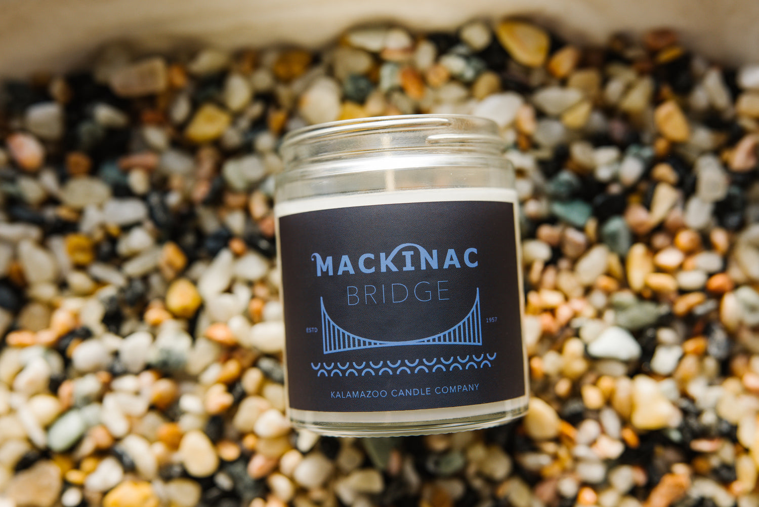 Mackinac Bridge Candle on bed of stones