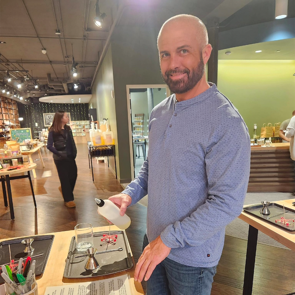 Man making his own soy candle at the candle bar