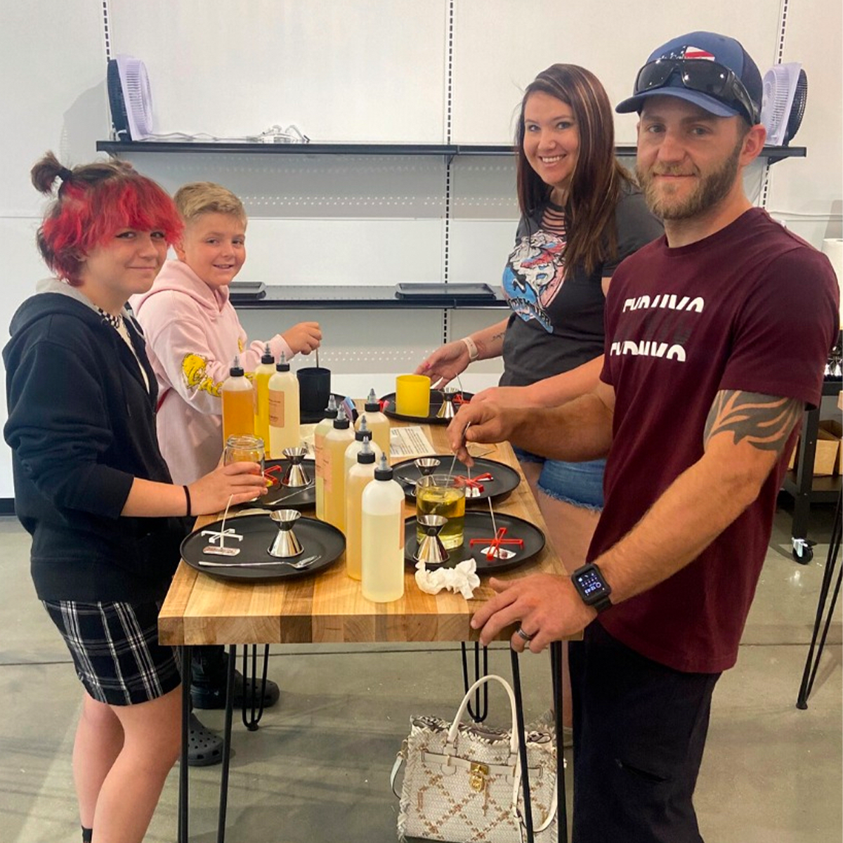 Family making candles together at the candle bar