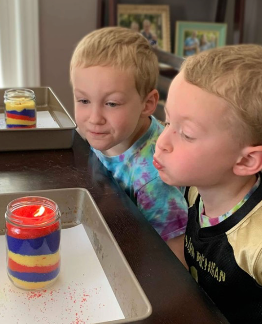 Two children with a sand candle