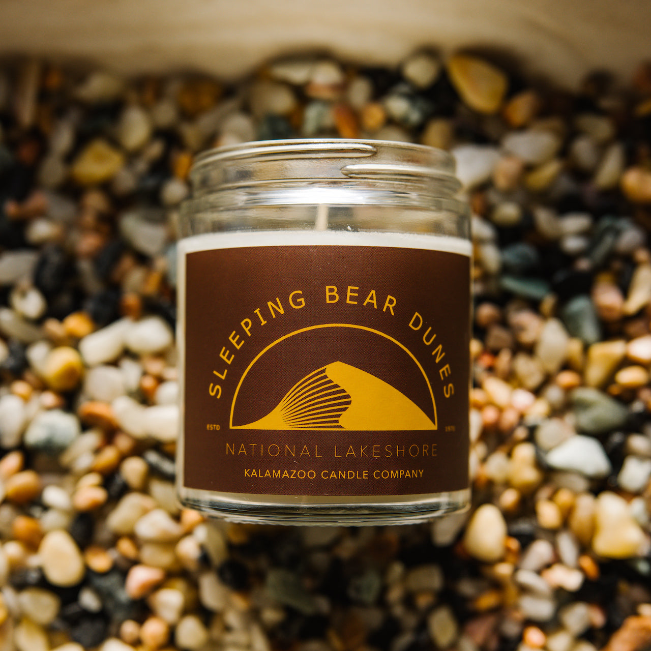 Sleeping Bear Dunes Candle on bed of stones
