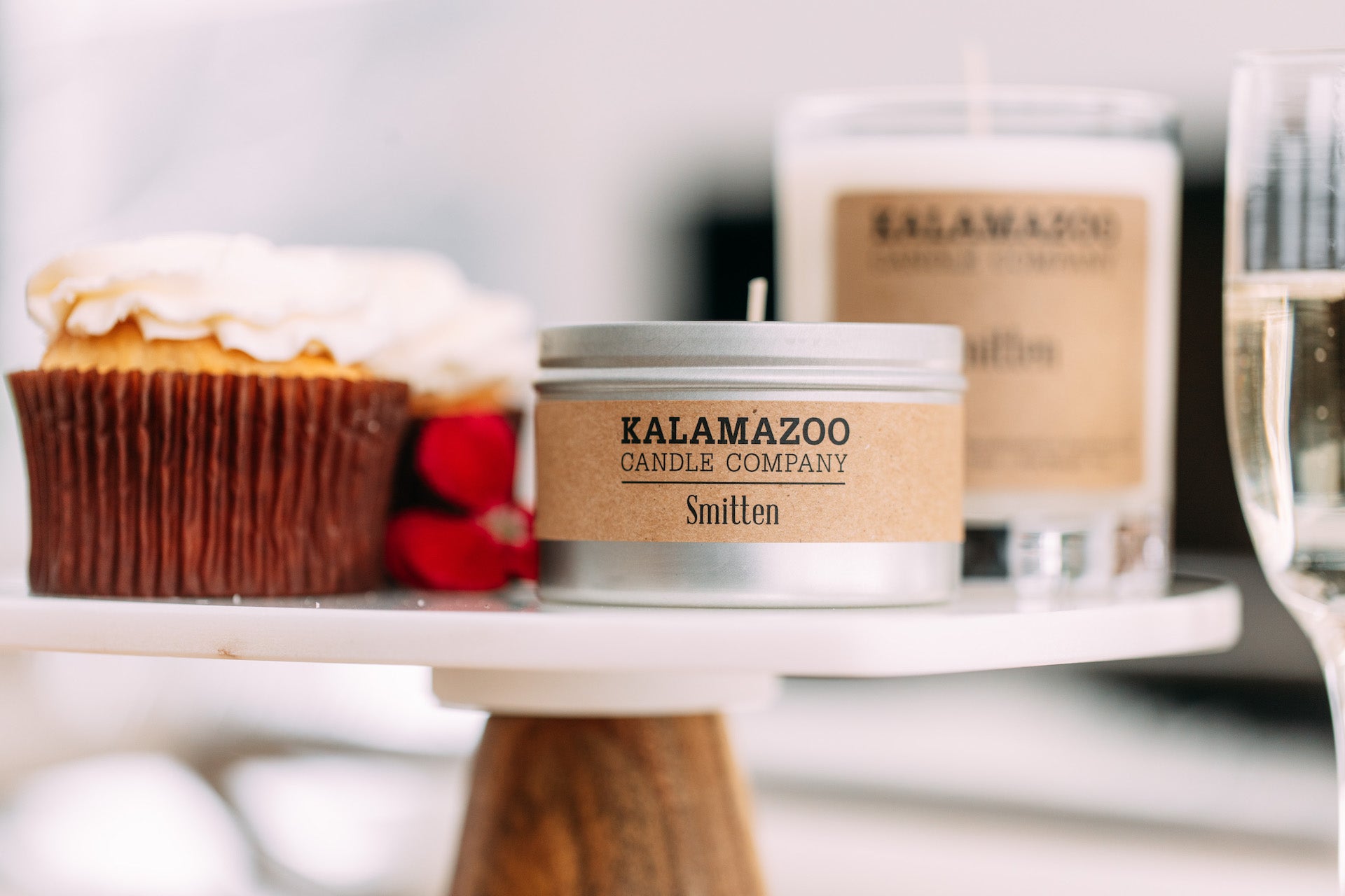 Smitten tin and jar next to baked goods