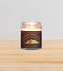 Graphic Sleeping Bear Dunes National Lakeshore jar candle filled with a warm and exotic earthy blend of sandalwood, bergamot, and nutmeg.